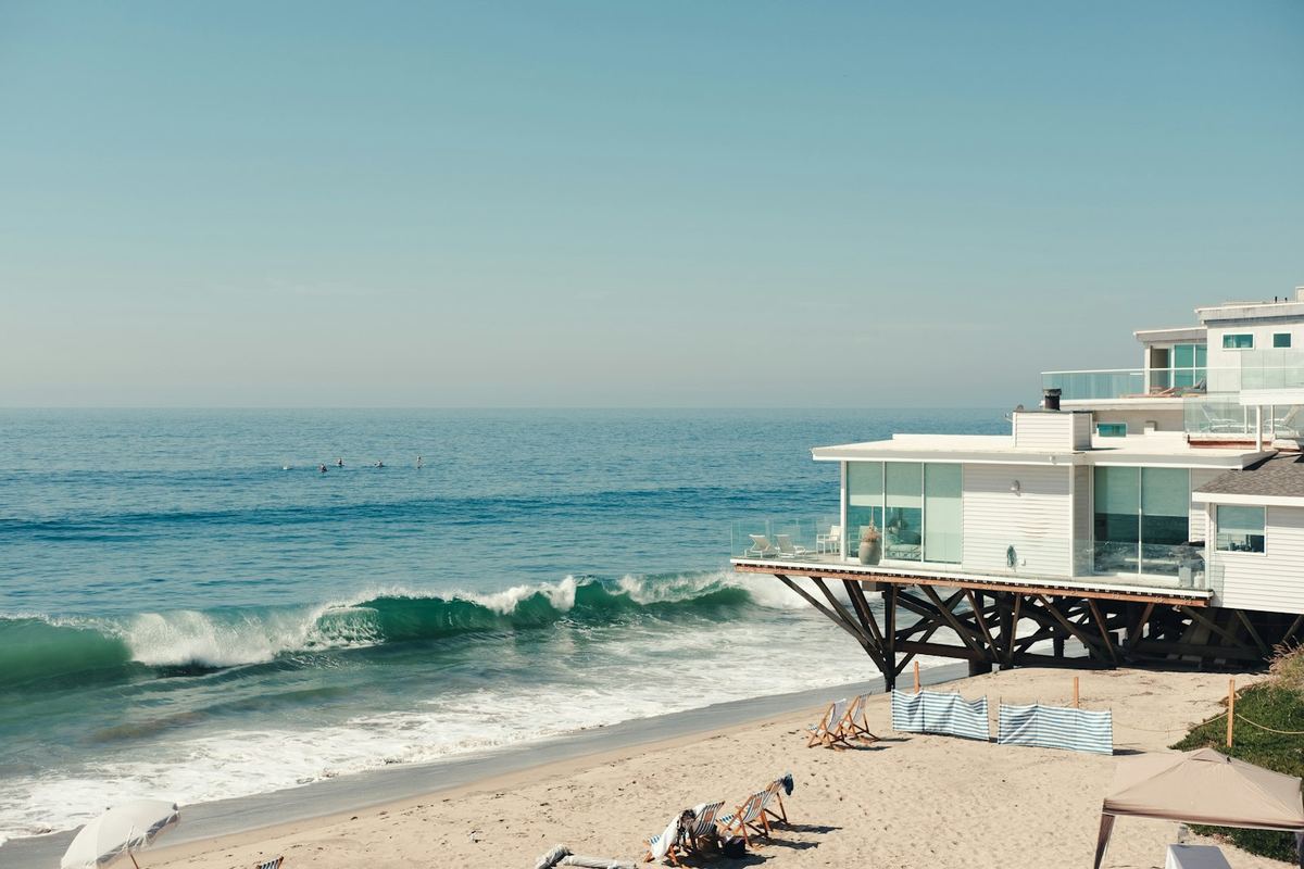 Modern house on a beach at the edge of the ocean