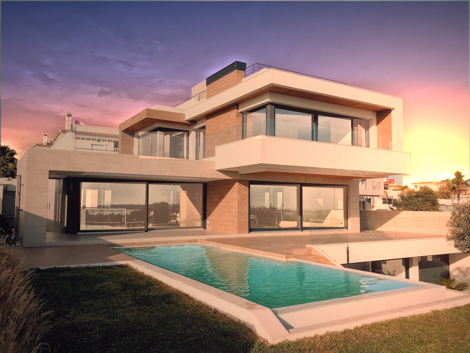 Contemporary villa with infinity pool at sunset